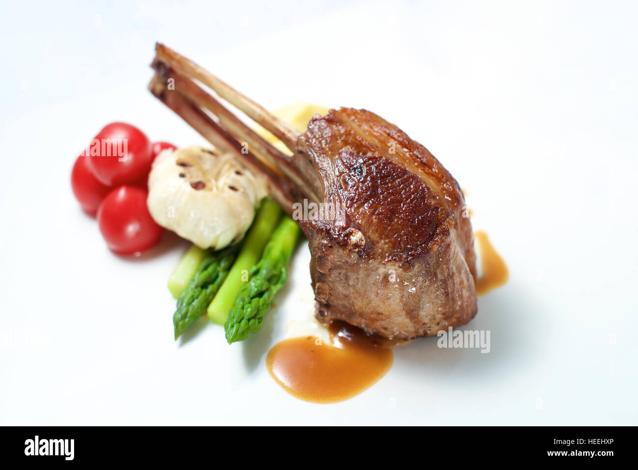 Lamb chop dish on a white plate Stock Photo - Alamy