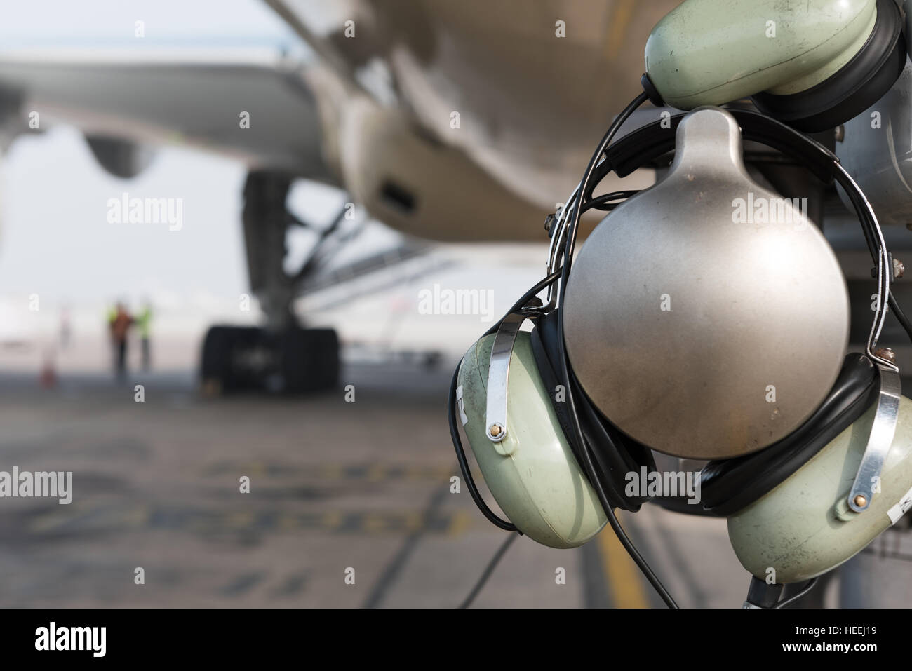 Time To Fly. Aviation Headset Resting On Part Of An Aircraft Nose Landing  Gear. Airplane Parked On Apron Stock Photo - Alamy