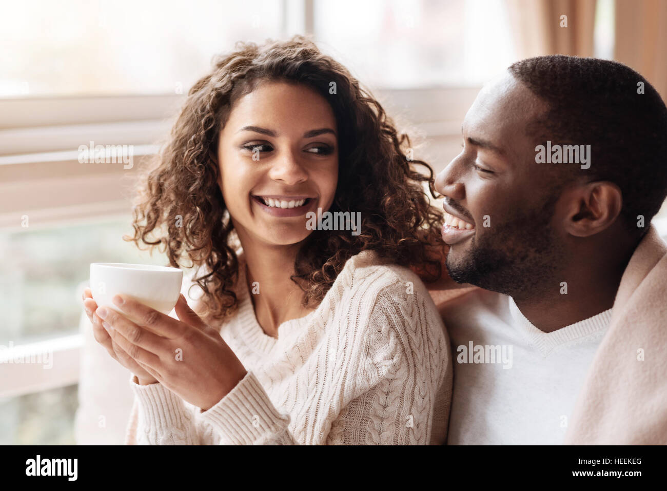 Cheerful African American couple enjoying tea in the cafe Stock Photo ...