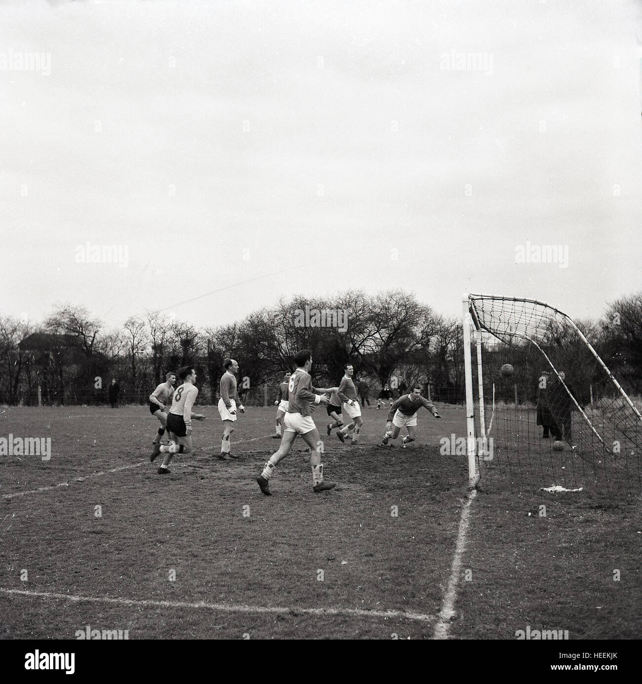 1960s, historical, amateur football match, players watch as the ball