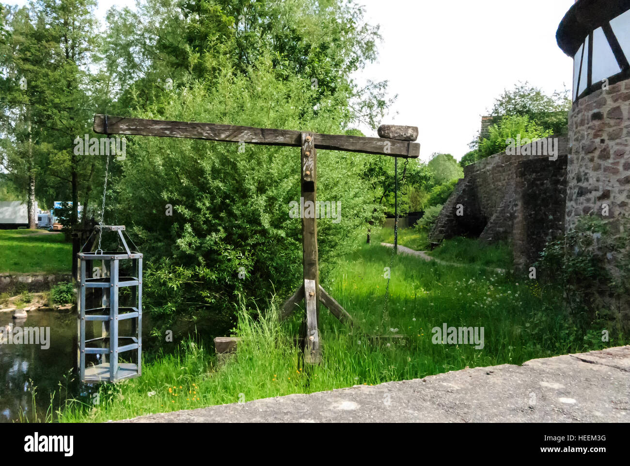 Witches cage - Medieval torture instrument at the river in Steinau an der Strasse, close to the birthplace Brothers Grimm, Germa Stock Photo
