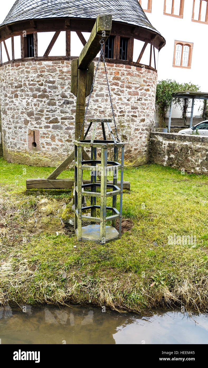 Witches cage - Medieval torture instrument at the river in Steinau an der Strasse, in Old Town close to birthplace Brothers Grim Stock Photo
