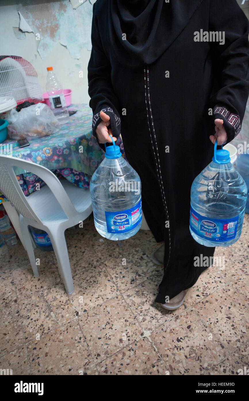 Families struggle to ration drinking water in the city of Zarqa, Jordan