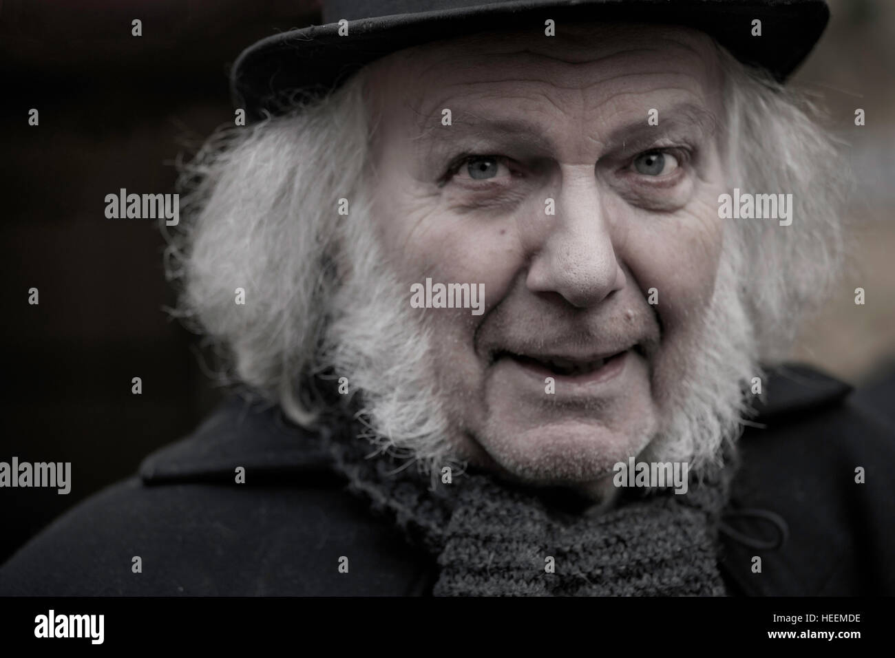 Close-up portrait of a man acting as Ebenezer Scrooge, a grumpy, mean old man at the Deventer Dickens Festival, The Netherlands. Stock Photo