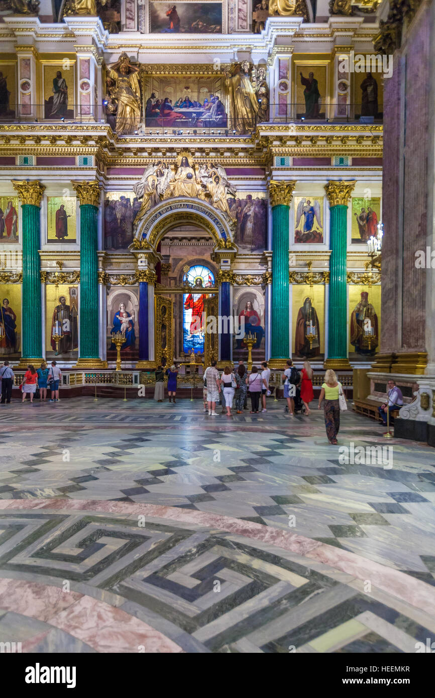 SAINT PETERSBURG, RUSSIA - JULY 26, 2014:  Tourists in the interior of St. Isaac's Cathedral looking at the main iconostasis Stock Photo