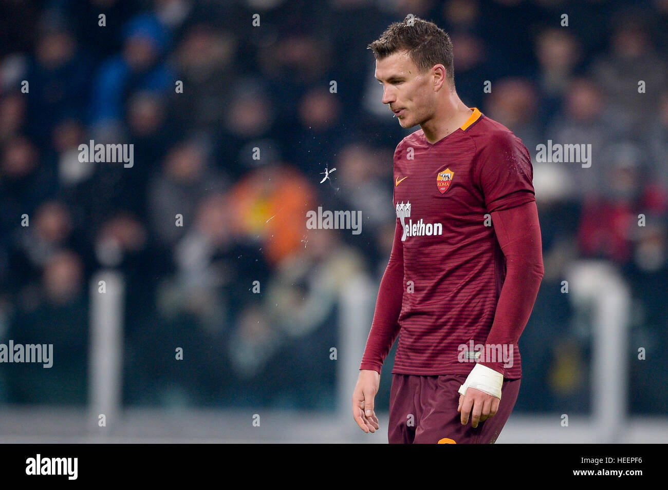 Turin, Italy. 2016, 17 december: Edin Dzeko of AS Roma spits during the Serie A football match between Juventus FC and AS Roma. Stock Photo