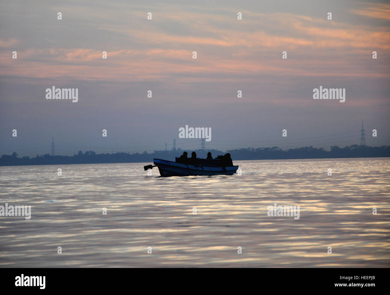 People traveling on a boat in a lake at dusk 3 Stock Photo - Alamy