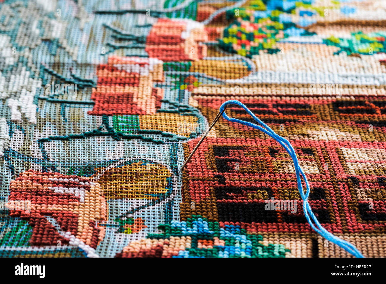 Needle and thread in a tapestry Stock Photo Alamy