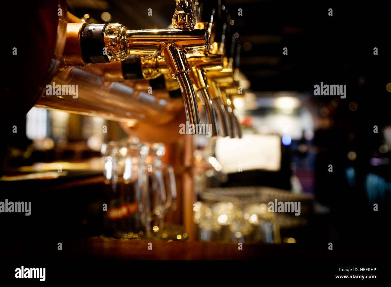 golden shiny beer taps in beer bar Stock Photo