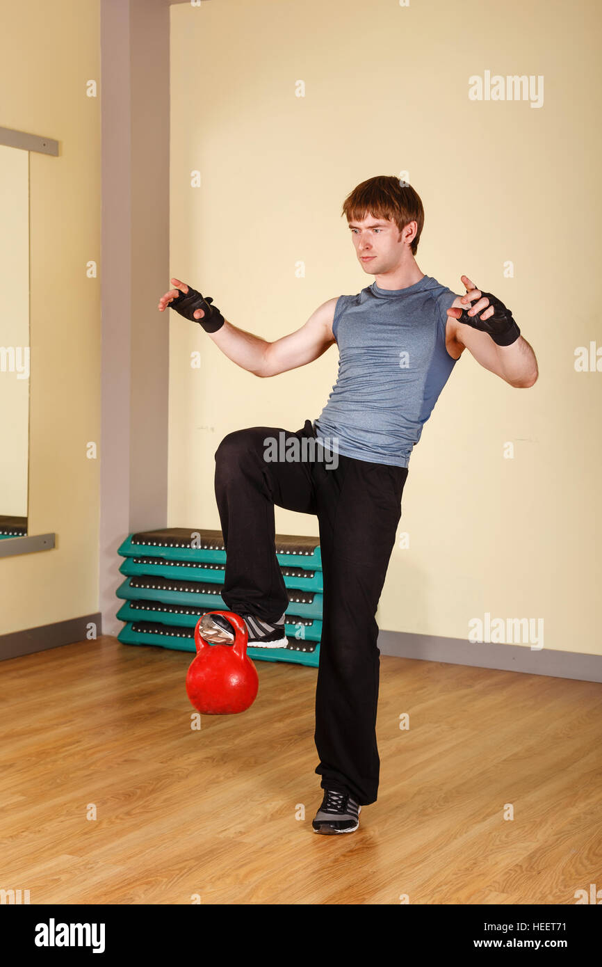 The Man Lifts The Weight On One Foot Train Strength And Balance Healthy Lifestyle Concept Fitness The Man Lifts The Weight On One Foot Train Strength And Balance Healthy Lifestyle Concept Fitness