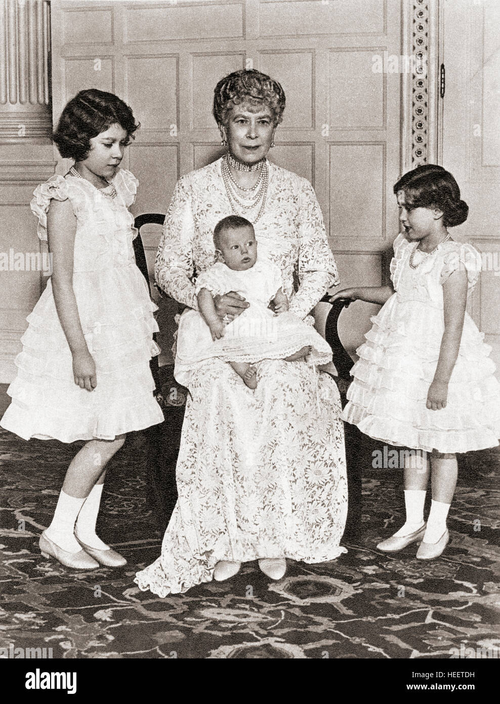 Mary of Teck with her grandchildren in 1936, Princess Elizabeth, left, Princess Margaret Rose, right and on her lap, Prince Edward.  Mary of Teck, 1867 – 1953.  Queen consort of the United Kingdom and the British Dominions and Empress of India as the wife of King-Emperor George V.  Princess Elizabeth, future Elizabeth II, 1926 - 2022.  Queen of the United Kingdom, Canada, Australia and New Zealand. Princess Margaret, Margaret Rose, 1930 – 2002, aka Princess Margaret Rose.  Younger daughter of King George VI and Queen Elizabeth. Prince Edward, Duke of Kent, born 1935. Stock Photo