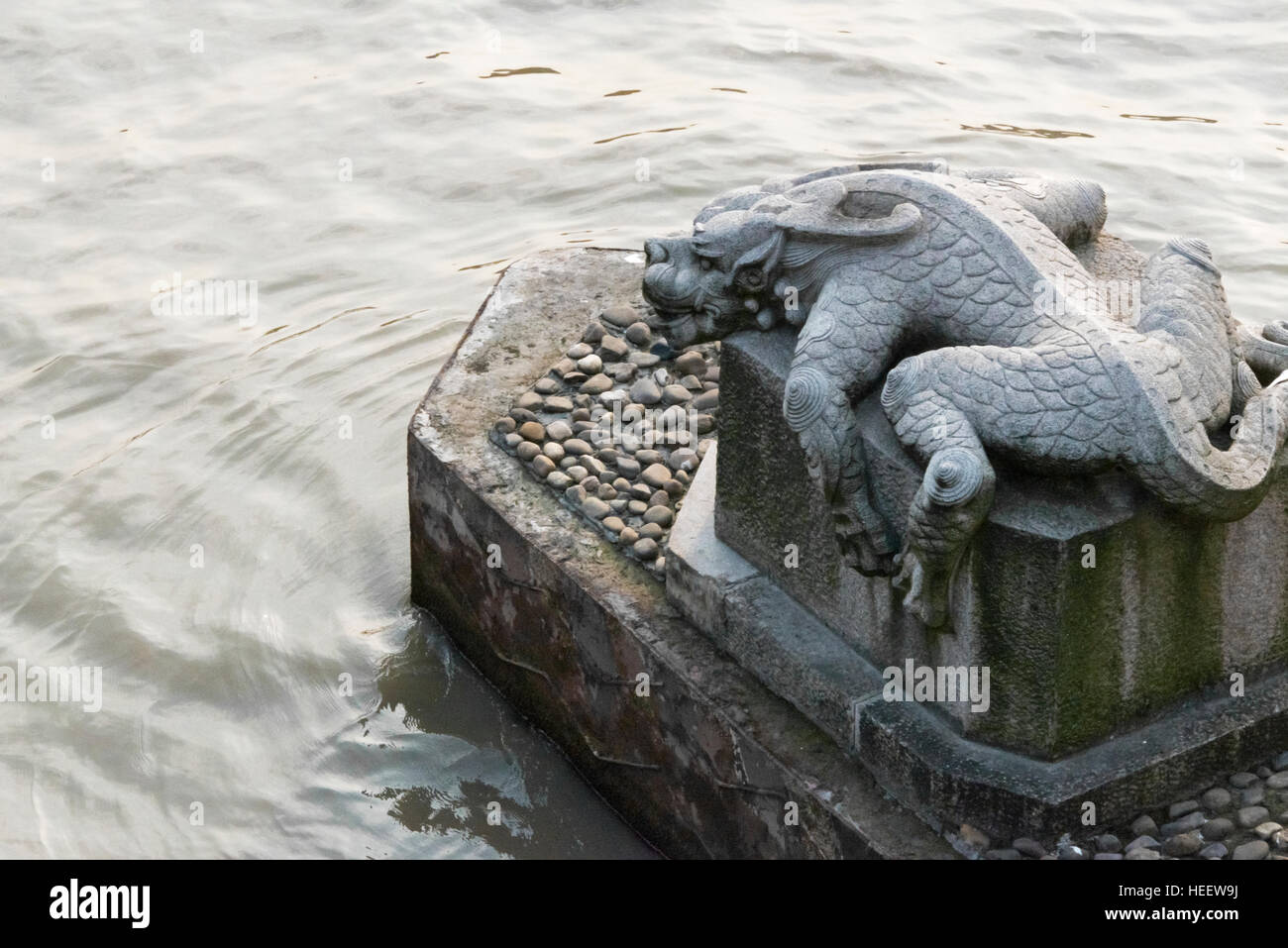 Statue of a legendary animal, Ba Xia, under Gongchen Bridge on Grand Canal, Hangzhou, Zhejiang Province, China Stock Photo