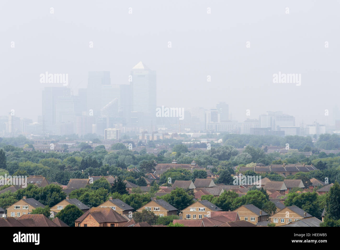 East London skyline, air pollution london, hazy day urban smog over city of London Canary Wharf, London on a warm summers afternoon, uk Stock Photo