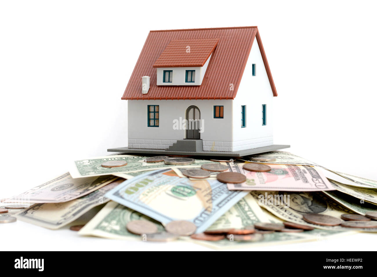 Model house on top of money pile suggesting savings for a house Stock Photo