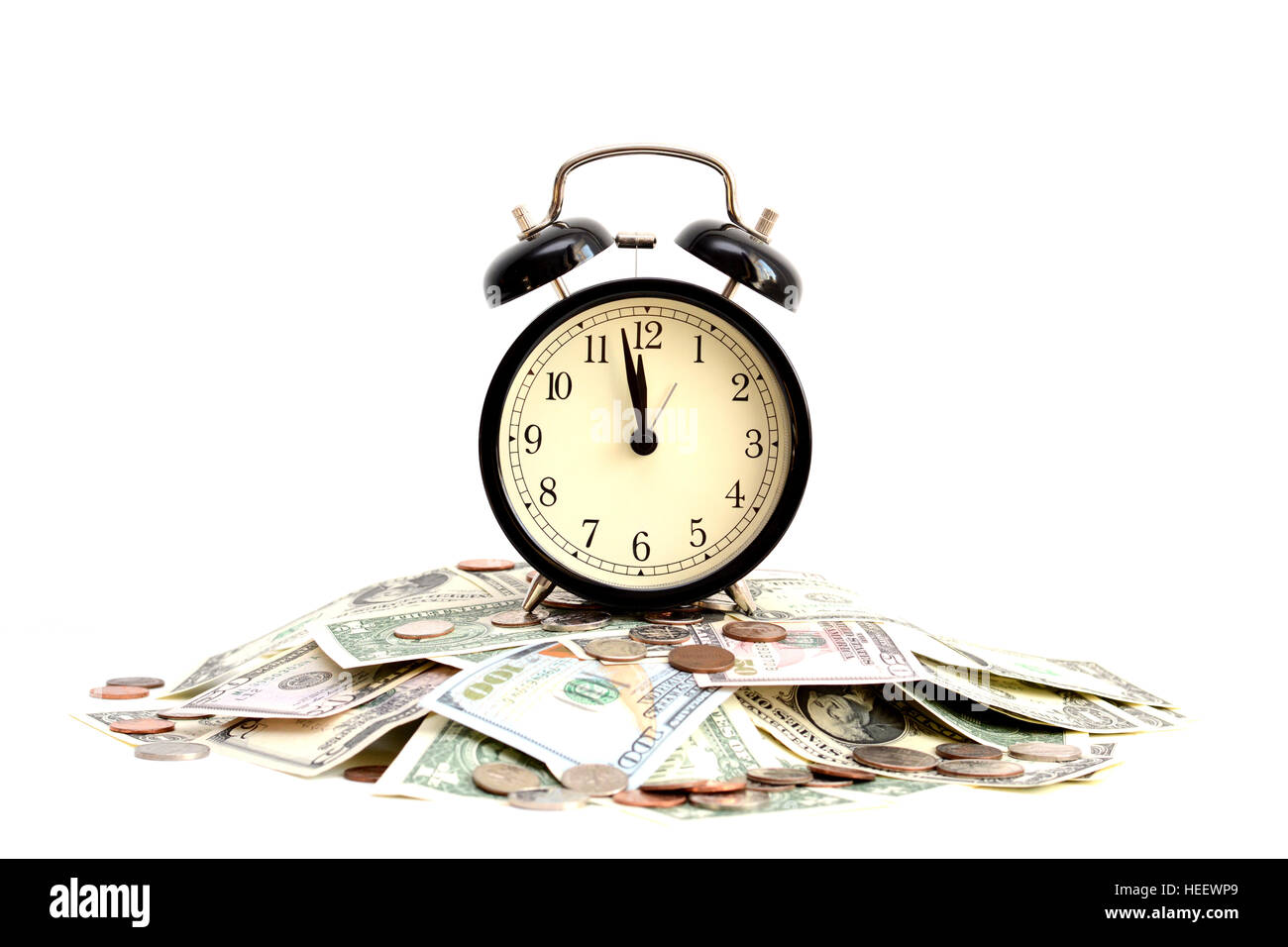 Time is money concept with close up of an old clock on dollar bills Stock Photo