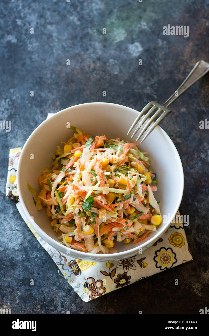 Fresh cabbage, corn and carrot coleslaw salad in bowl, mayonnaise ...