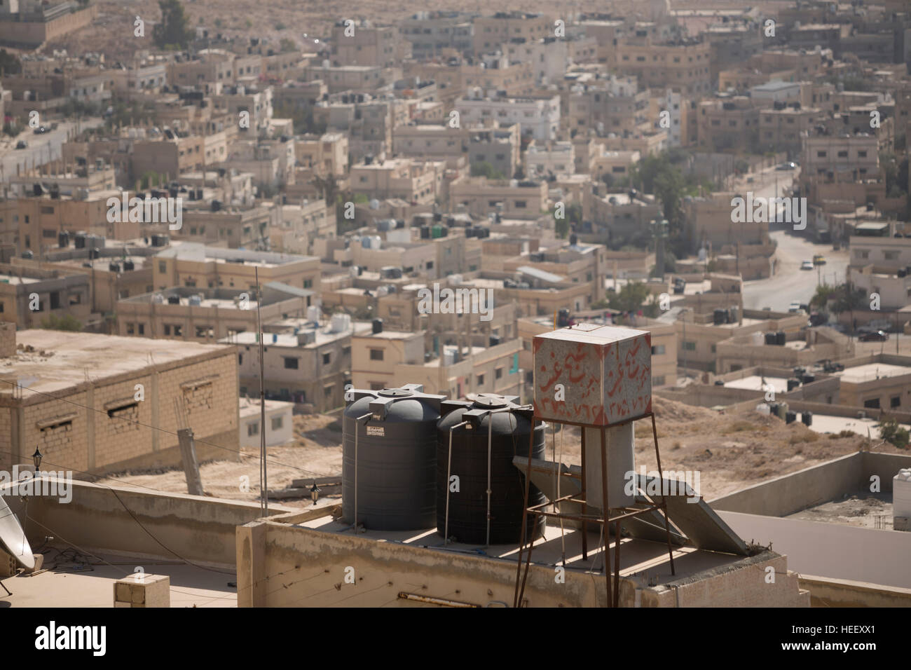 Water storage tanks sit on a rooftop in Zarqa, Jordan. Stock Photo