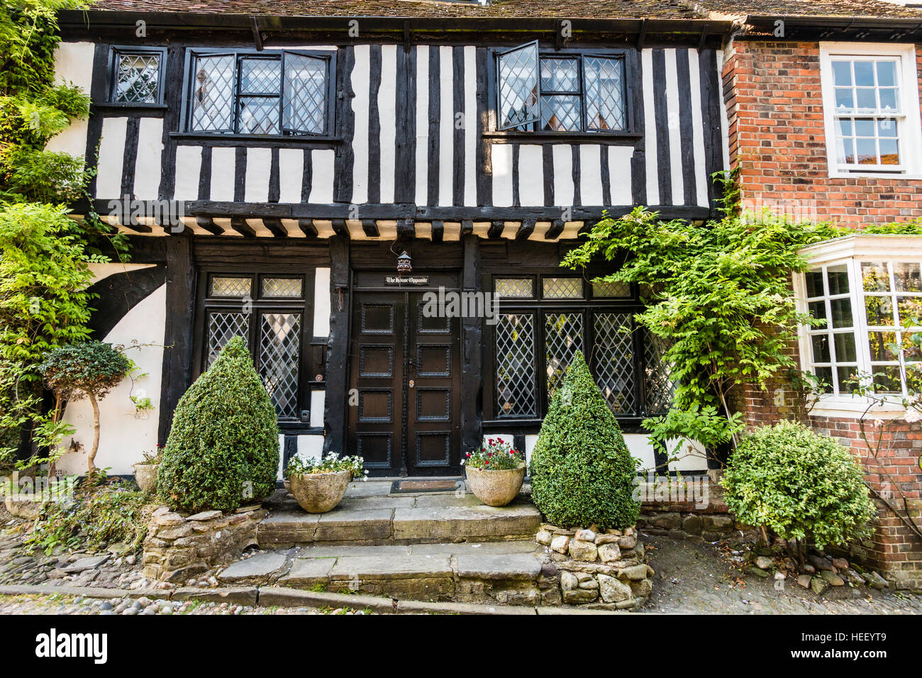 Historical English town of Rye. 15th century timber framed Tudor black and white cottage, the House Opposite'. Front, entrance. Stock Photo