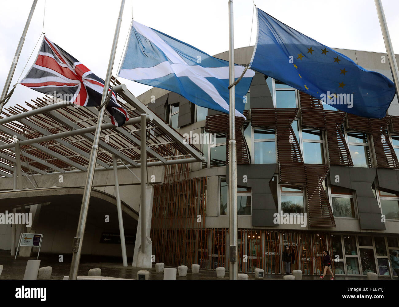 A Union flag, a Saltire flag and an European Union flag fly outside the Scottish Parliament in Edinburgh. Scotland's First Minister Nicola Sturgeon has said that losing losing Scotland's place in the single market would be 'potentially devastating' to the country's long-term prosperity. Stock Photo