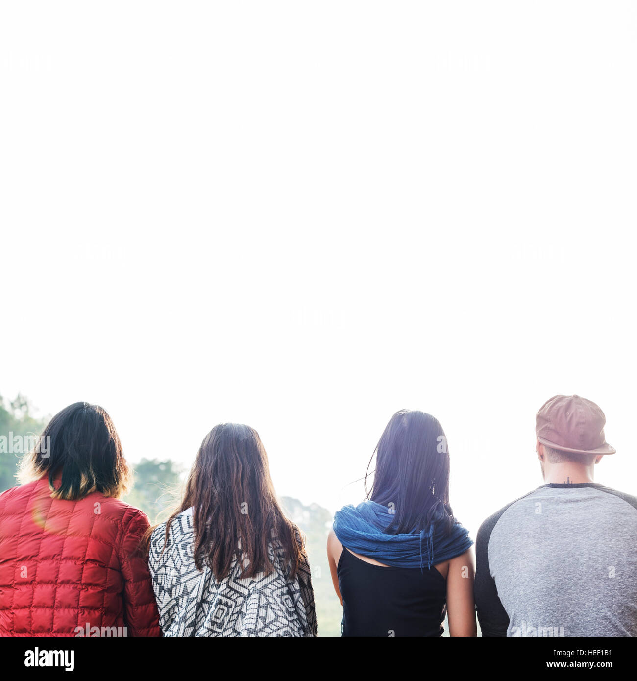 Friends Sitting in a Row Outdoors Concept Stock Photo - Alamy