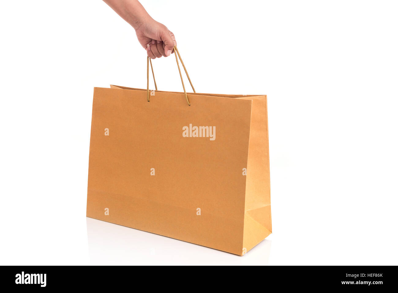 Close up hand holding brown paper bag isolated on white background ...