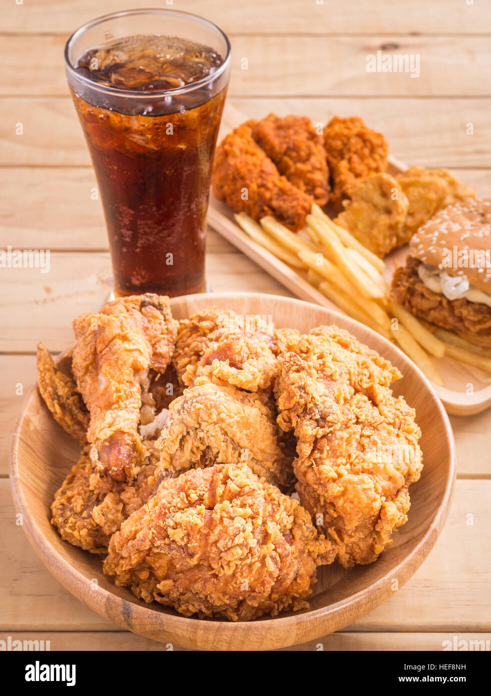 Close up fried chicken, french fries and soft drink on wooden table Stock Photo