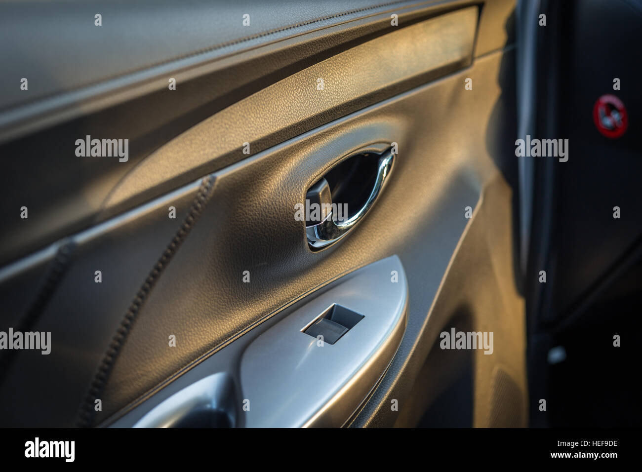 Detail of new modern car interior, Focus on door handle Stock Photo