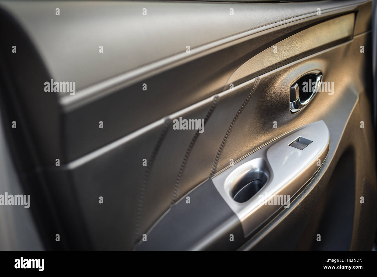 Detail of new modern car interior, Focus on door handle Stock Photo