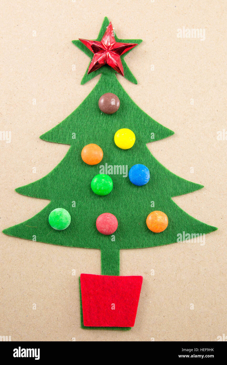 Christmas tree decorated with sweet bonbons and star shaped ornament Stock Photo