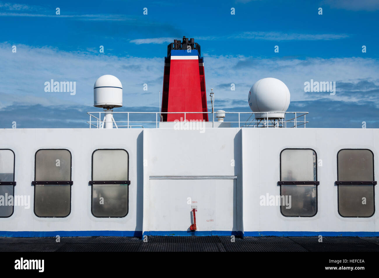Stena Line red ferry funnel and deck details against blue skies. Stock Photo