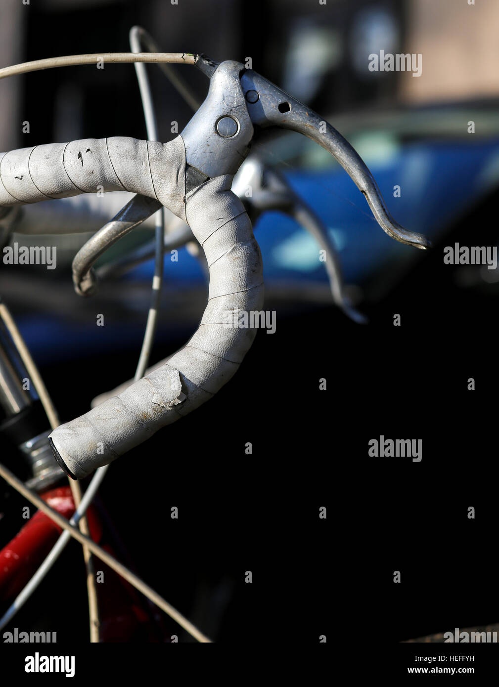 Focus on handle grip of white vintage racing bike on dark background Stock Photo