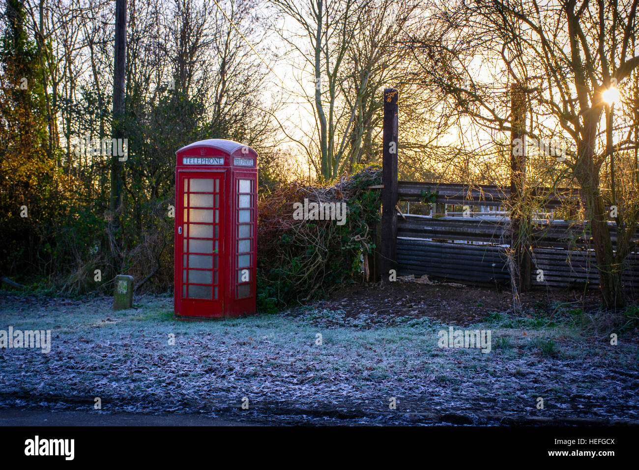 a red telepphone box in a countryside setting on a frosty morning Stock Photo
