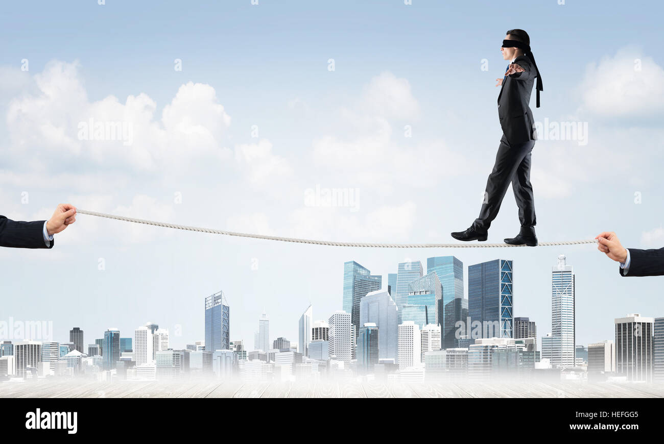 Business concept of risk support and assistance with man balancing on ...