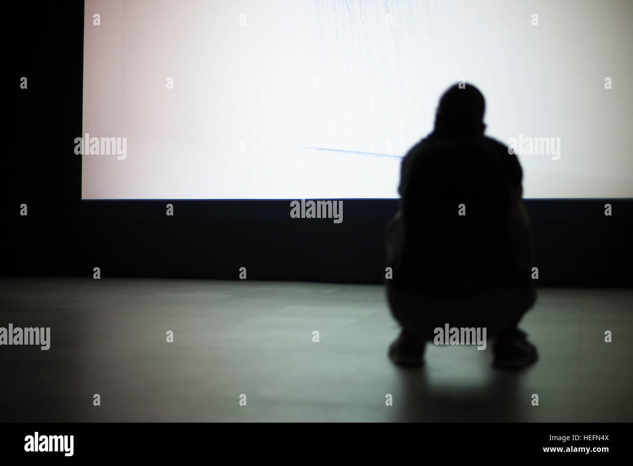 Silhouette of a man sat Stock Photo