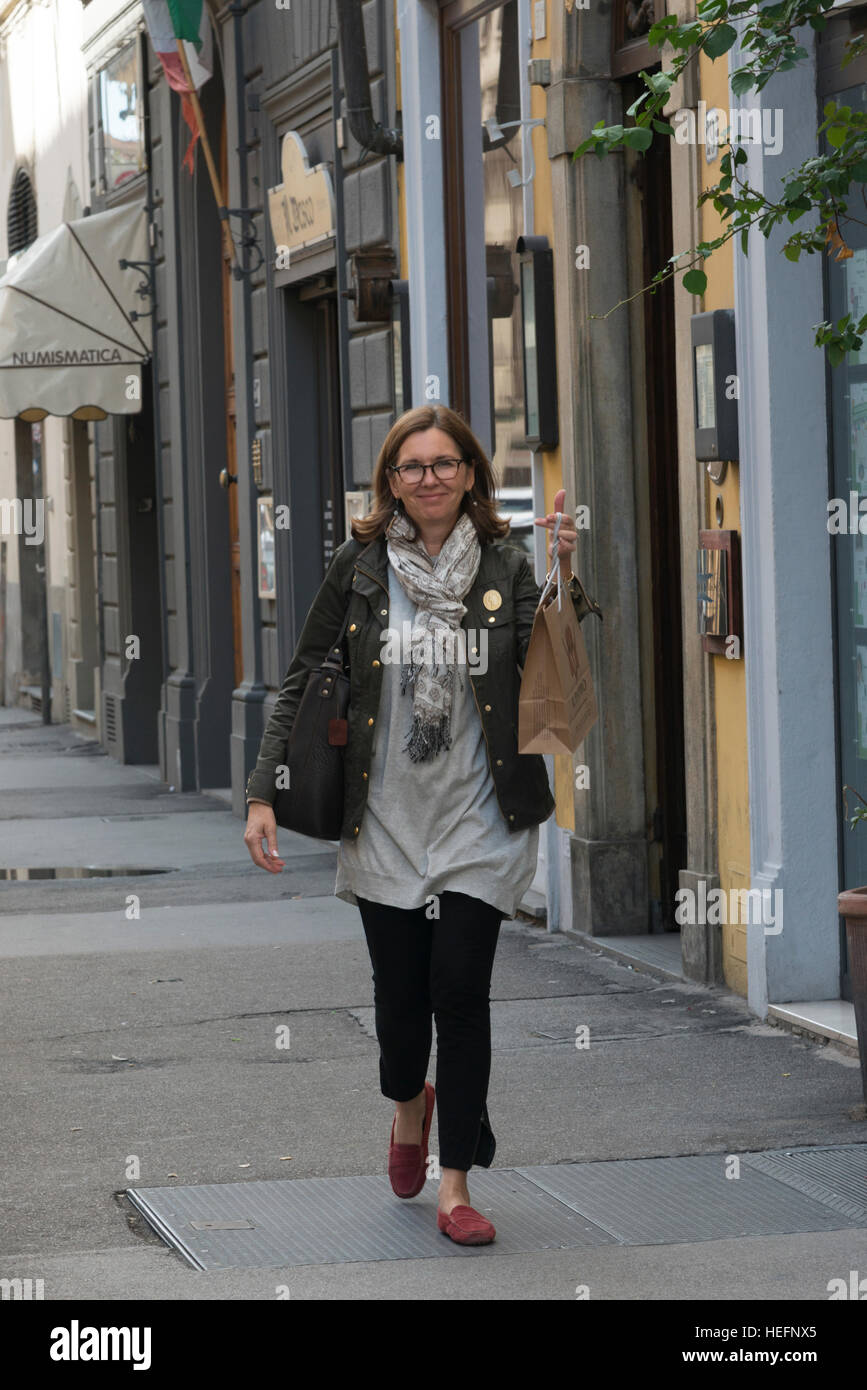 Mature woman walking on street hi-res stock photography and images - Alamy