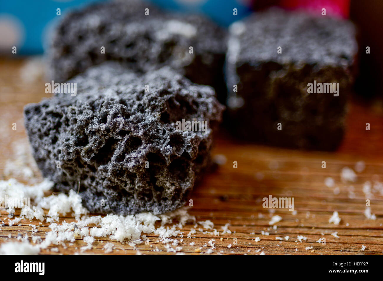 closeup of some pieces of candy coal on a rustic wooden table Stock Photo