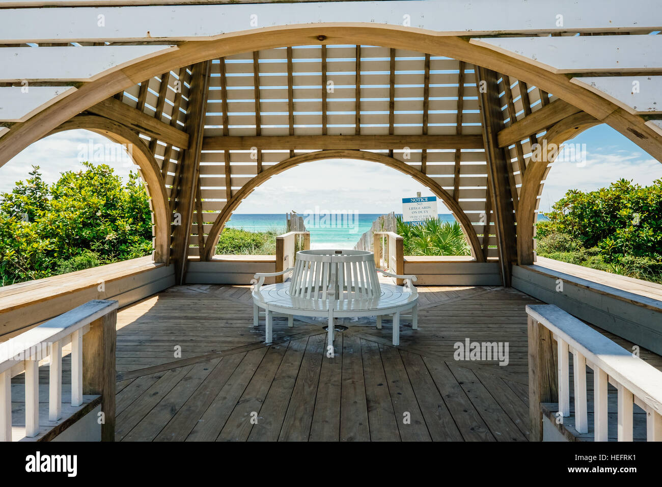 Beachside pavilion in Seaside Florida with white sand beach and clear blue Gulf of Mexico water in the background. Stock Photo
