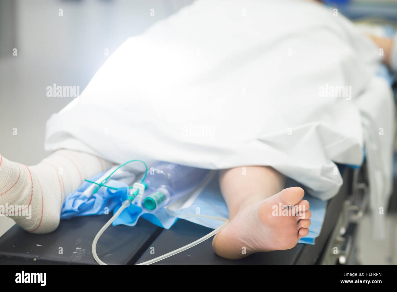 Post Operative Beding Hospital surgery bed and patient with leg bandaged post operation in ...