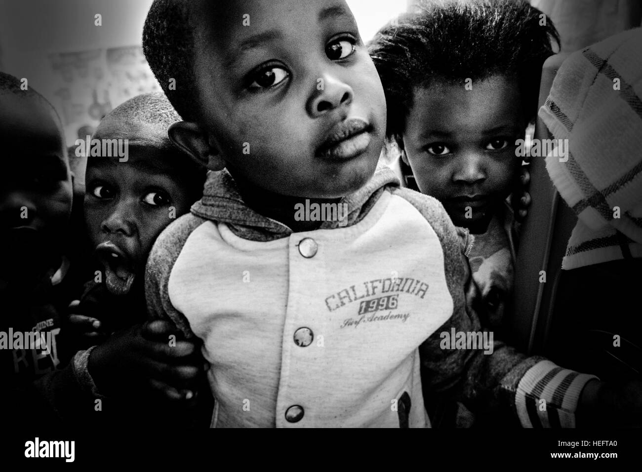 Children pose for a photo in a school in a township in Cape Town. The school is supported bu the Uthando community project, which works across a number of townships in the city. Stock Photo
