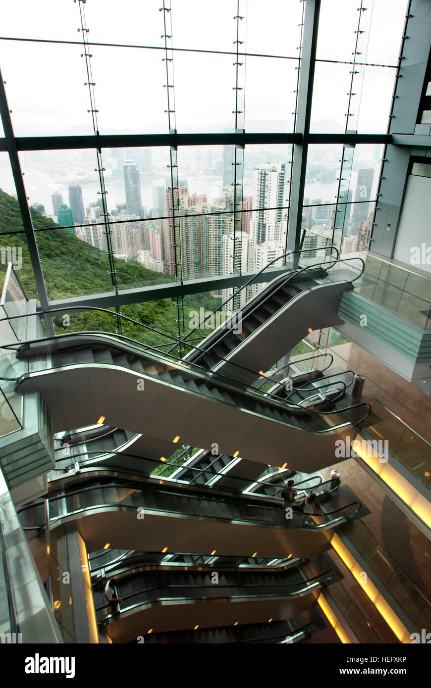 Visitors on escalators inside the Victoria New Peak Tower, Hong Kong, China Stock Photo