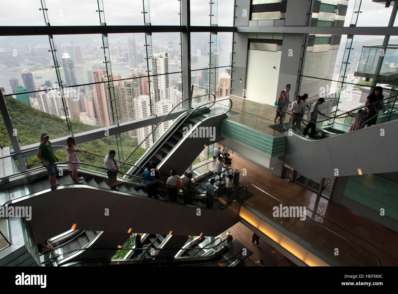 Visitors on escalators inside the Victoria New Peak Tower, Hong Kong, China Stock Photo