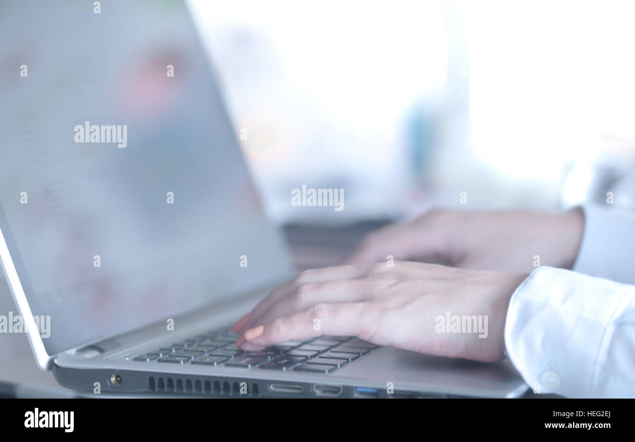 Female hands typing on a laptop Stock Photo