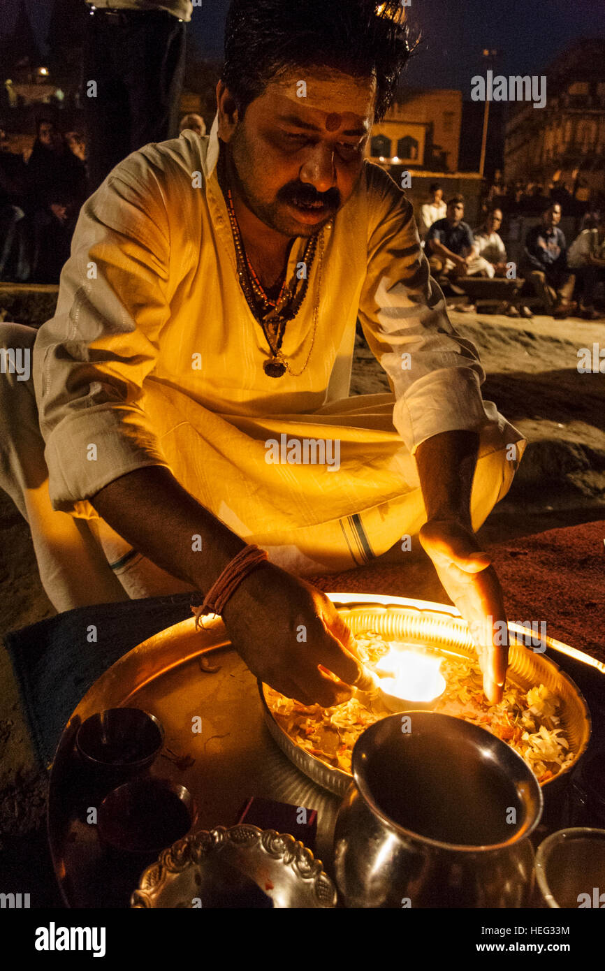 Hindu brahmin priest performs a fire ritual at night in Varanasi, Uttar Pradesh, India, Asia Stock Photo