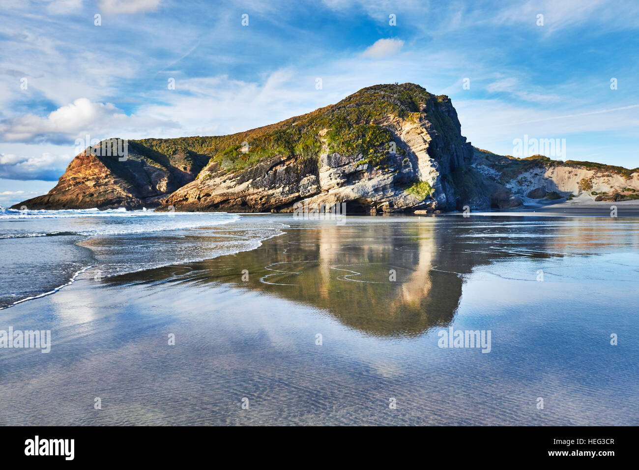 New Zealand, Puponga, Wharariki, rock formations on the beach, reflections in wet Sand Stock Photo