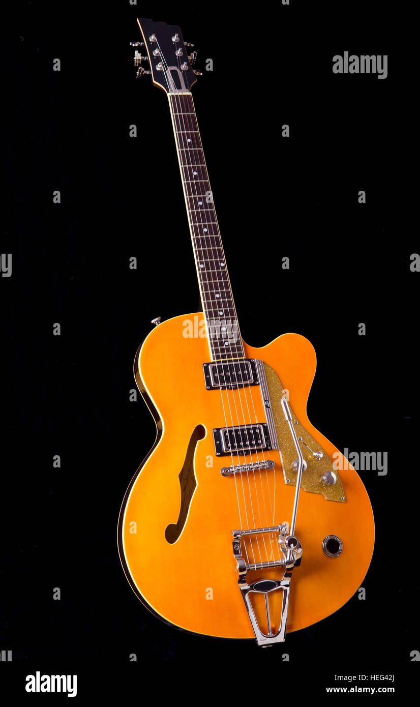 Archtop guitar, semi acoustic, front view with headstock, neck, fingerboard, body with cutaway, tailpiece Stock Photo