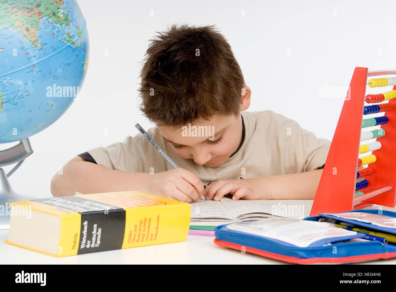 Schoolboy, seven-year-old boy doing his homework Stock Photo