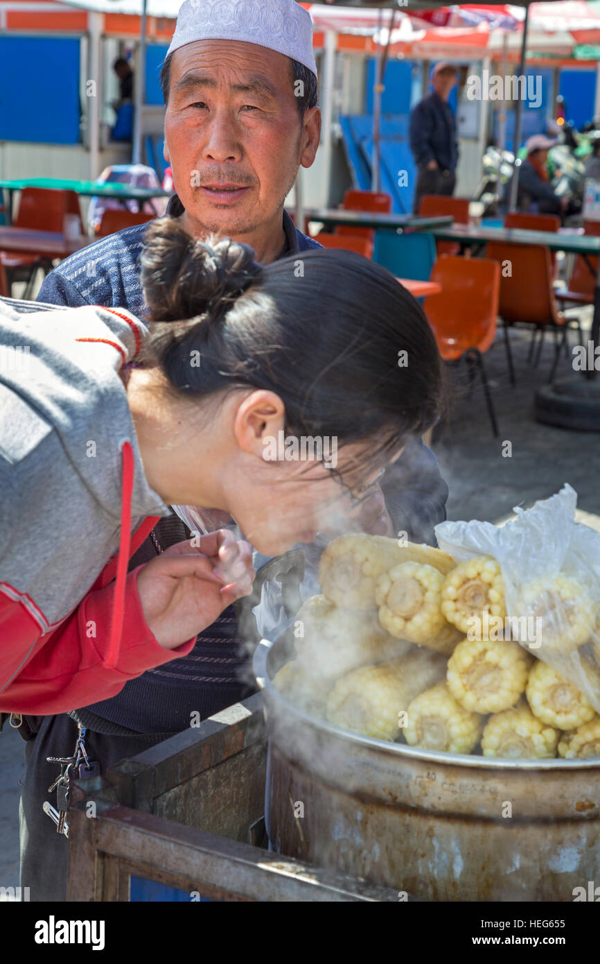 Chinese customer and vendor at food stall in a market in Shizuishan, Ningxia, China Stock Photo