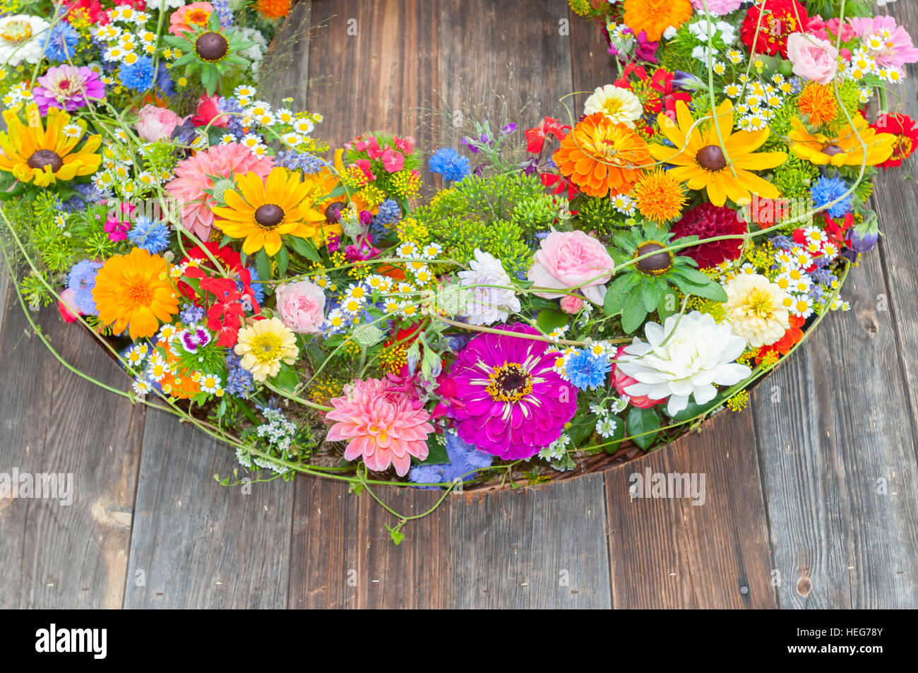 garland with spring flowers on wooden underground Stock Photo