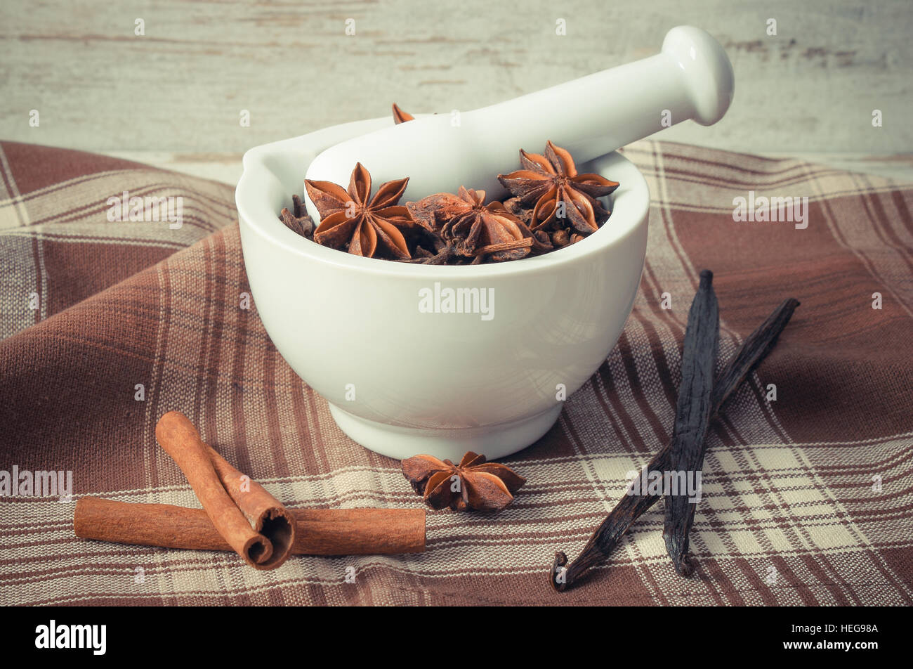 Vintage photo, Fragrant cloves and anise in white glass mortar and