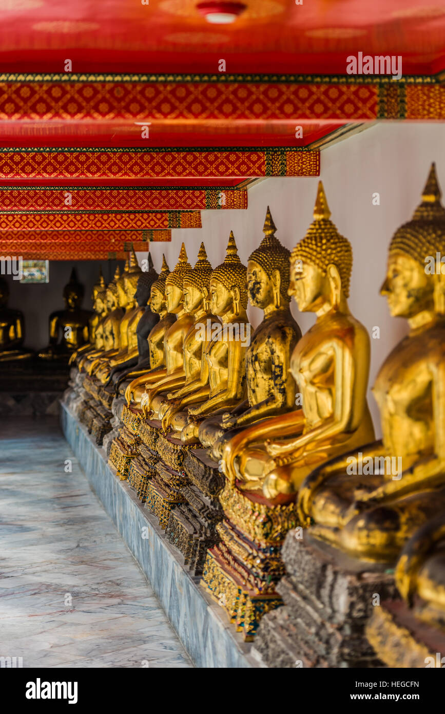 aligned golden buddha statues at Wat Pho temple Bangkok Thailand Stock ...
